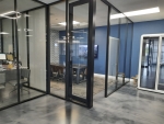 NxtWall glass conference room with fabric side walls and black aluminum frame swing door #1620