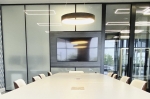 Conference area with Formica Blackened Steel laminate finish decorative wall panels and glass side walls. #1613