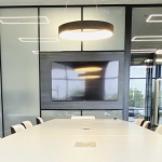 Conference area with Formica Blackened Steel laminate finish decorative wall panels and glass side walls. #1613