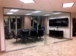 Double swing frameless glass doors on glass conference room walls #0579