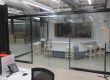 Office space with glass partitions and interior frameless glass door