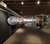 Flex Series Feature Wall with Stainless Steel LED Logo - NxtWall Chicago Showroom