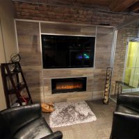 Freestanding Flex Series Laminate Plank Wall Detail with Integrated Media and Fireplace