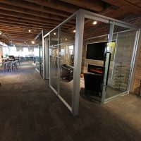 Freestanding View / Flex Series Lounge Room with Laminate plank wall panels and integrated tv monitor